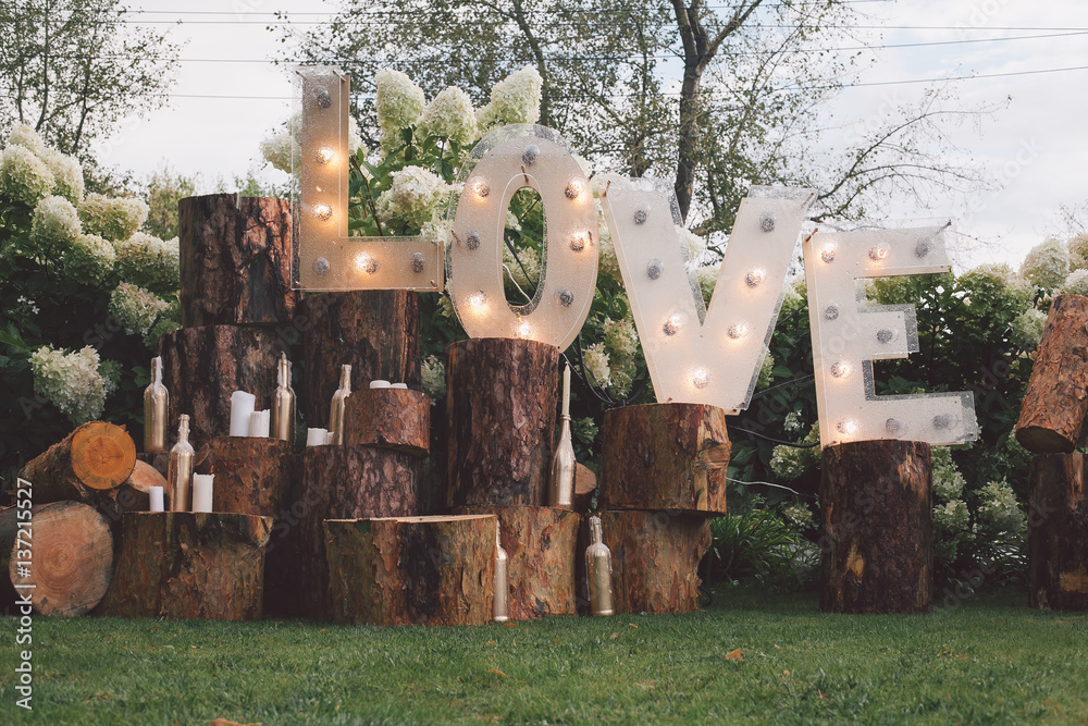 light up love sign on tree trunk sections wedding decor the wedding marketplace